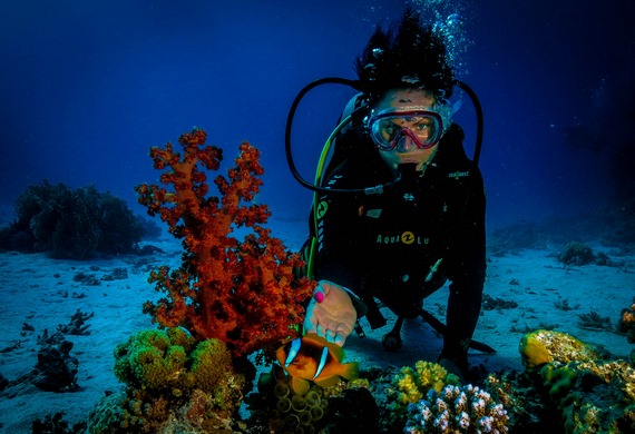 Beginner scuba diver exploring coral reefs